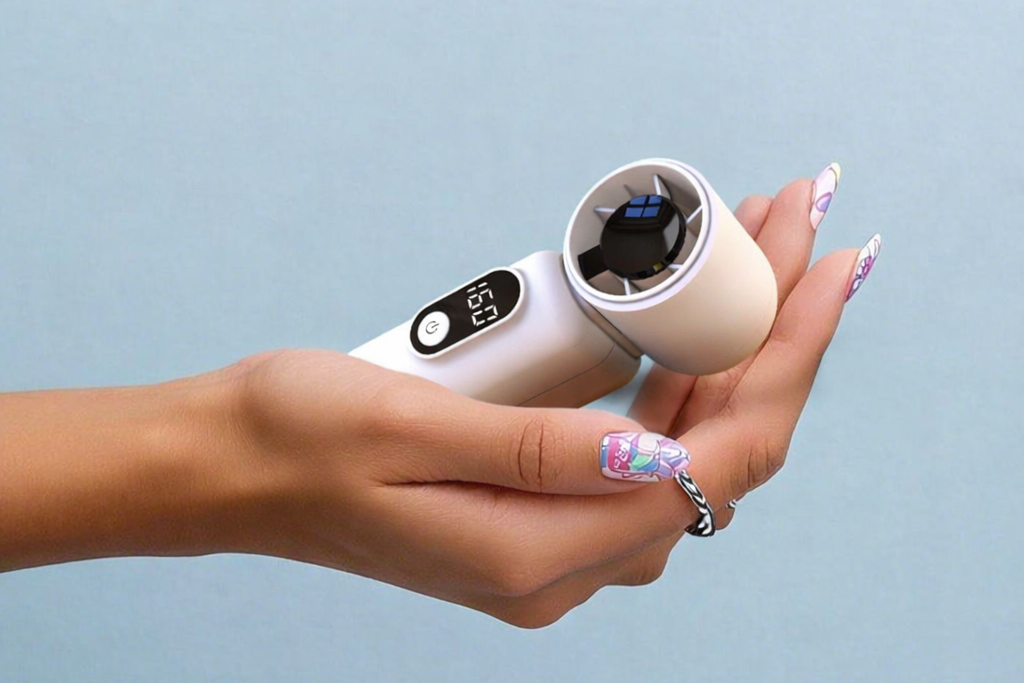 Holding a powerful handheld fan with a digital display